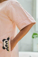 Person wearing a pink striped shirt with a panda design.