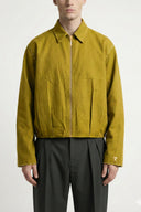 Person wearing a mustard yellow jacket on a white background