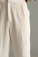 Close-up of beige pants with a neutral background