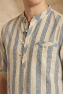 Close-up of a person wearing a striped shirt with beige and blue horizontal stripes.