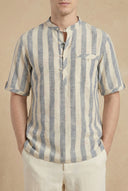 Man wearing a striped shirt with a beige background